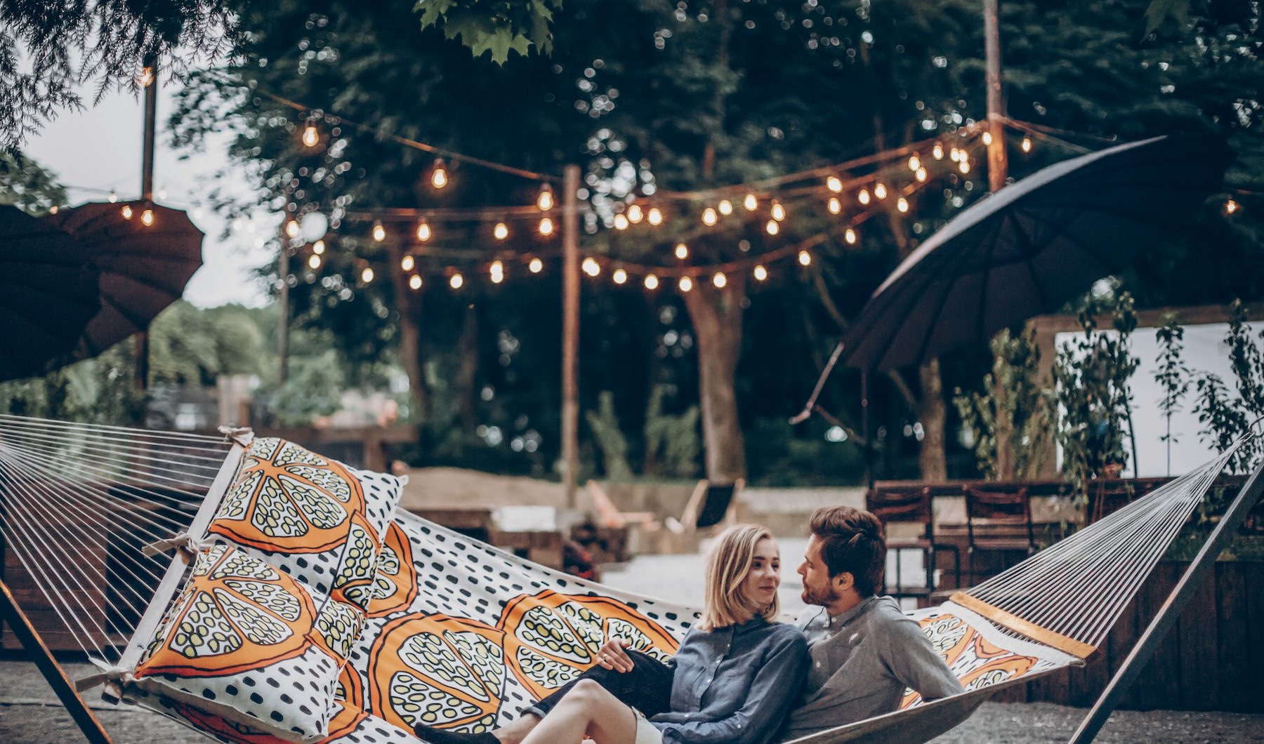 a couple sitting in a hammock