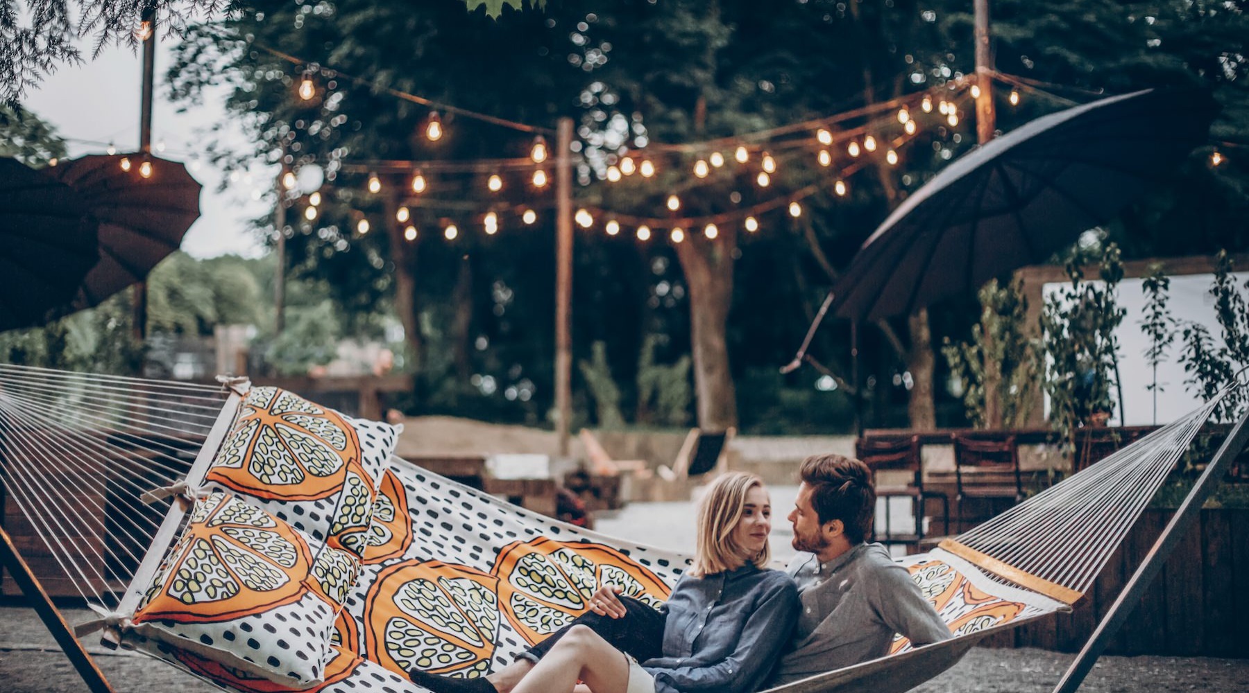 a couple sitting in a hammock